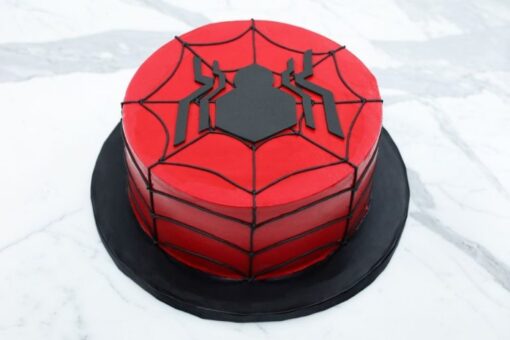 Amazing Spidey Cake with red and blue icing, web patterns, and Spiderman topper.