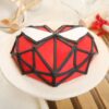 Spiderman Piñata Cake decorated with red fondant, black webbing, white eyes, and candy-filled center