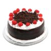Black Forest cake topped with whipped cream, cherries, and chocolate shavings.