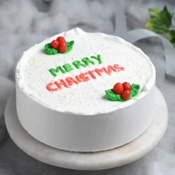 Festive Vanilla Christmas Cake – vanilla cake decorated with festive floral designs and holiday accents.