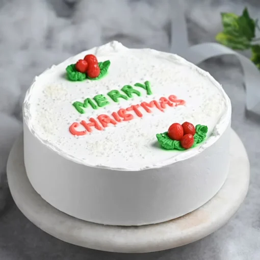 Festive Vanilla Christmas Cake – vanilla cake decorated with festive floral designs and holiday accents.