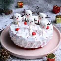 Holiday Velvet Miniature Cake with red velvet base and holiday figurines