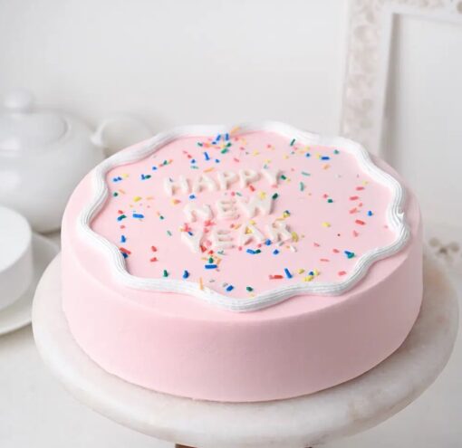 New Year Vanilla Charm cake with white frosting and elegant New Year decoration