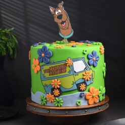 Scooby-Doo themed birthday cake with colorful layers and character toppers