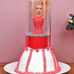 Pull-Up Barbie Doll Cake with red and pink frosting and a Barbie doll centerpiece.