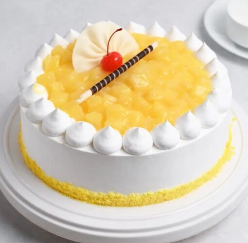 Creamy Pineapple Paradise cake with whipped cream frosting and fresh pineapple slices.