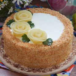 Pineapple & Rose Blossom Cake with tropical pineapple layers and rose blossom decorations.