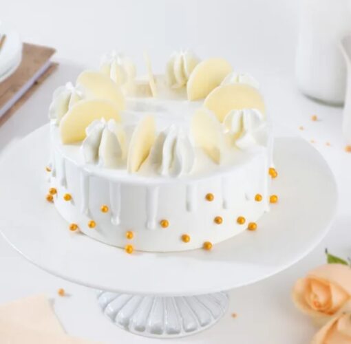Snowy White Cream Cake with fluffy white frosting and delicate decoration.