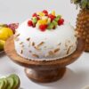 Festive Fruit Celebration Cake topped with assorted fresh fruits and creamy frosting.