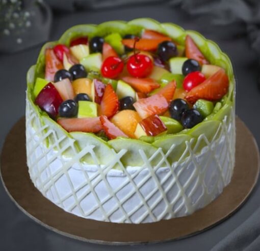 Mixed Fruit Delight Cake topped with fresh colorful fruits and creamy frosting.
