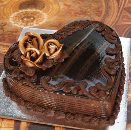 Heart-shaped Chocolate Truffle Delight cake with smooth chocolate ganache and decorative toppings.
