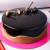 Decadent Chocolate Truffle Cake with glossy chocolate ganache and chocolate shavings.