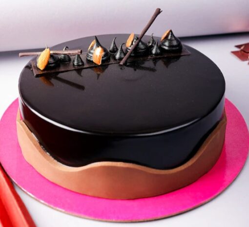 Decadent Chocolate Truffle Cake with glossy chocolate ganache and chocolate shavings.