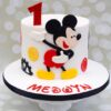 Colorful Mickey Mouse Celebration Cake decorated with fondant and edible character toppers.