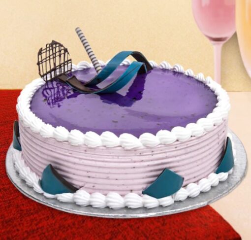 Black Currant Cream Cake with layers of creamy frosting and fresh black currants on top.