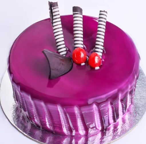Black Currant Delight Cake topped with fresh black currants and creamy frosting, perfect for special occasions.