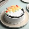 Sunny Pineapple Bliss Cake topped with fresh pineapple slices and tropical decorations, perfect for celebrations.