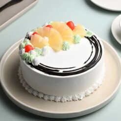 Sunny Pineapple Bliss Cake topped with fresh pineapple slices and tropical decorations, perfect for celebrations.
