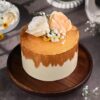 Elegant Golden Bloom Wedding Cake with intricate floral designs and golden accents on a white fondant base