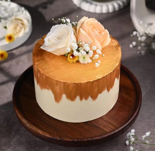 Elegant Golden Bloom Wedding Cake with intricate floral designs and golden accents on a white fondant base