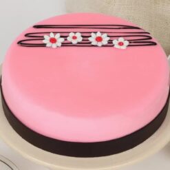 Pink Strawberry Bloom Cake topped with fresh strawberries and floral decorations